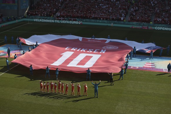 A giant jersey in support of Danish player Christian Eriksen is displayed ahead of the Euro 2020 soccer championship group B match between Denmark and Belgium at the Parken stadium in Copenhagen, Denmark, Thursday, June 17, 2021. Christian Eriksen was hospitalized after collapsing during Denmarks match with Finland. (Hannah McKay/Pool via AP)