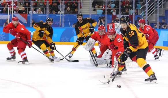 epa06563168 Patrick Hager of Germany (R, in yellow) in action against the OAR defense during the Men&#039;s Ice Hockey Gold Medal Game between the Olympic Athlete from Russia (OAR) and Germany at the  ...