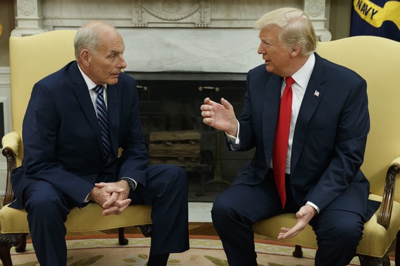 FILE - President Donald Trump talks with White House Chief of Staff John Kelly after he was privately sworn in during a ceremony in the Oval Office in Washington, July 31, 2017. (AP Photo/Evan Vucci,  ...