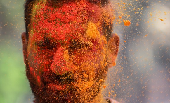 epa09104952 Revellers covered with powdered colours celebrate the Holi festival in Mumbai, India, 29 March 2021. Due to the massive Covid-19 spike many states including Maharashtra, Delhi, Madhya Prad ...