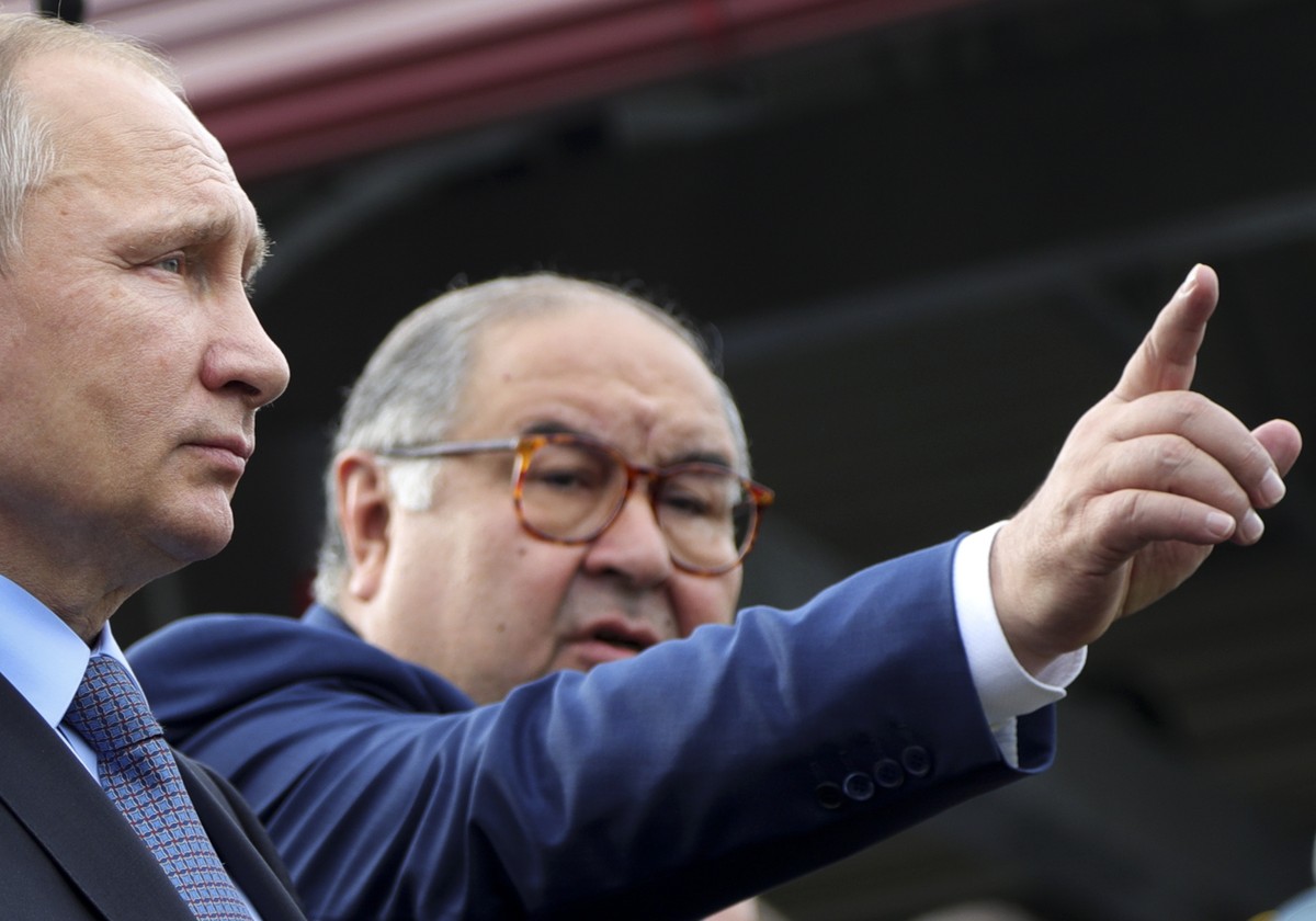 FILE - Russian businessman and founder of USM Holdings, Alisher Usmanov, points while speaking to Russian President Vladimir Putin, left, at the Lebedinsky GOK JSC, in Gubkin, Belgorod Region, Russia, ...