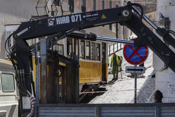 epa12351979 Technicians make an assessment of the accident of the Gloria funicular in Lisbon, a popular transportation used by tourists, after it derailed the previous day in Lisbon, Portugal, 04 Sept ...
