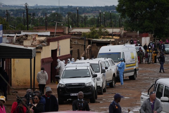 South African police gather at the scene of a mass shooting where gunmen killed nine and injured at least 10 in a pub in Bekkersdal, South Africa, Sunday, Dec. 21, 2025. (AP Photo/ Alfonso Nqunjana)
S ...