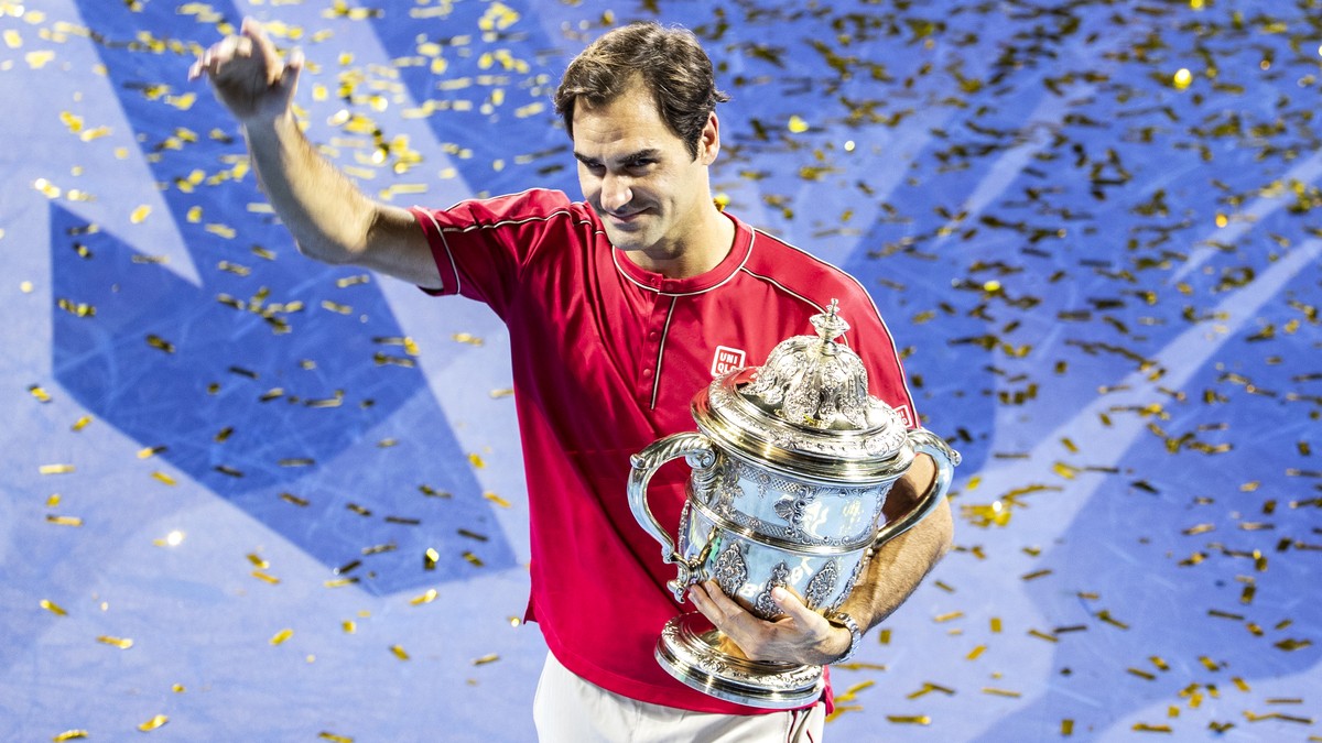 Roger Federer of Switzerland poses with his trophy after defeating Alex De Minaur of Australia after the final match at the Swiss Indoors tennis tournament at the St. Jakobshalle in Basel, Switzerland ...