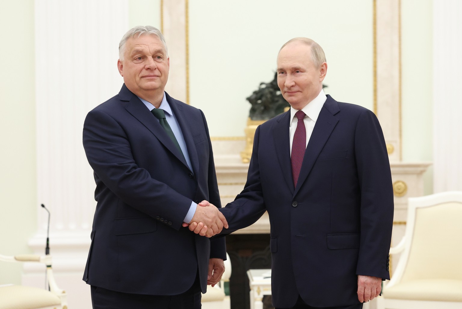 epa11458764 Russian President Vladimir Putin (R) shakes hands with Hungarian Prime Minister Viktor Orban (L) during a meeting at the Kremlin, in Moscow, Russia, 05 July 2024. Orban arrived in Moscow o ...