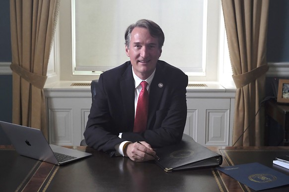 Virginia Gov. Glenn Youngkin sits at his desk inside his private office at the State Capitol in Richmond, Va., Wednesday, Jan. 18, 2022. The desk he chose to use was formerly used by Gov. Jim Gilmore  ...