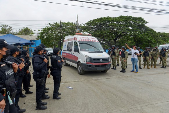 epa09580504 An ambulance exits the penitentiary of Guayaquil, Ecuador, 13 November 2021. A total of 58 inmates died and another 12 were injured in a new massacre registered in the Guayaquil penitentia ...