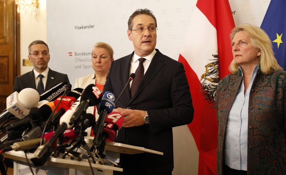 epa07580317 Austria&#039;s Vice-Chancellor Heinz Christian Strache (C) of the Austrian Freedom Party (FPOe) gives a statement to journalists as Interior Minister Herbert Kickl (L) and Foreign Minister ...