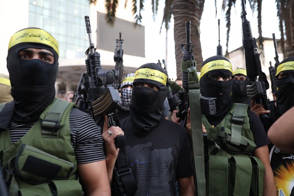 epa10176007 Palestinian militants members of Al-Aqsa Brigades, the armed wing of the Palestinian Fatah movement, hold guns during a rally in support of Palestinian prisoner and cancer patient Nasser A ...
