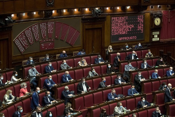 Members of parliament wearing face masks attend a session at the Chamber of Deputies in Rome, Wednesday, Oct. 7, 2020. ItalyÄôs health minister said that the government is examining a proposal to mak ...