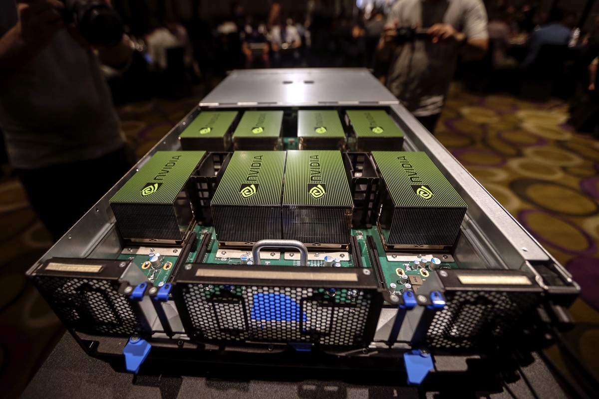epa08669639 (FILE) - People have a look at the NVIDIA DGX-1, described as the 'World's First Deep Learning Supercomputer' during a news conference ahead of the COMPUTEX, the largest com ...