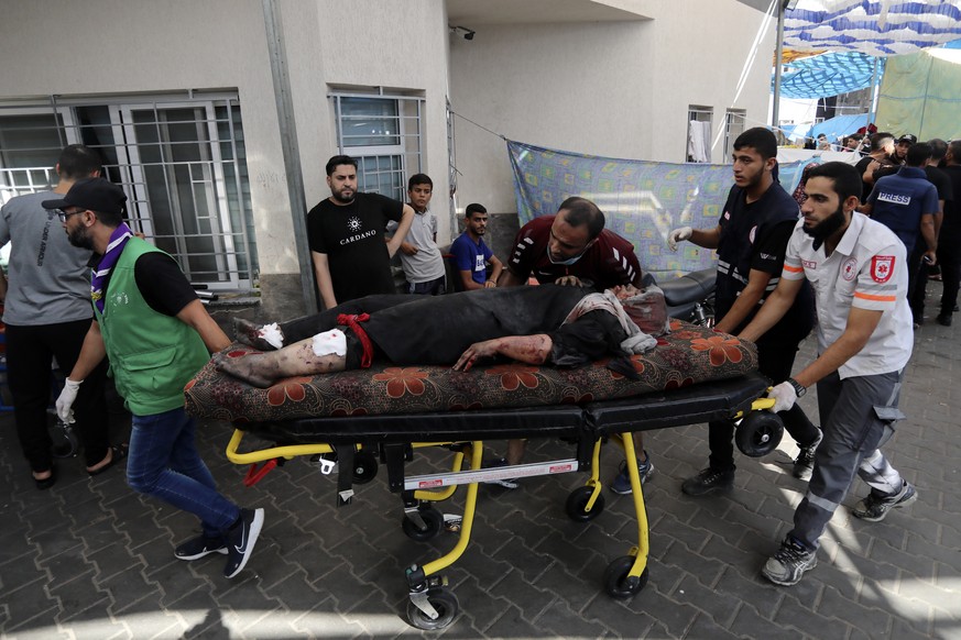 An injured Palestinian woman is wheeled into the al-Shifa hospital, following Israeli airstrikes on Gaza City, central Gaza Strip, Sunday, Nov. 5, 2023. (AP Photo/Abed Khaled)