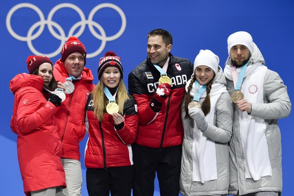 Jenny Perret and Martin Rios of Switzerland (silver medal), Kaitlyn Lawes and John Morris of Canada (gold medal) and Anastasia Bryzgalova and Aleksandr Krushelnitckii (OAR, bronce medal), from left, p ...