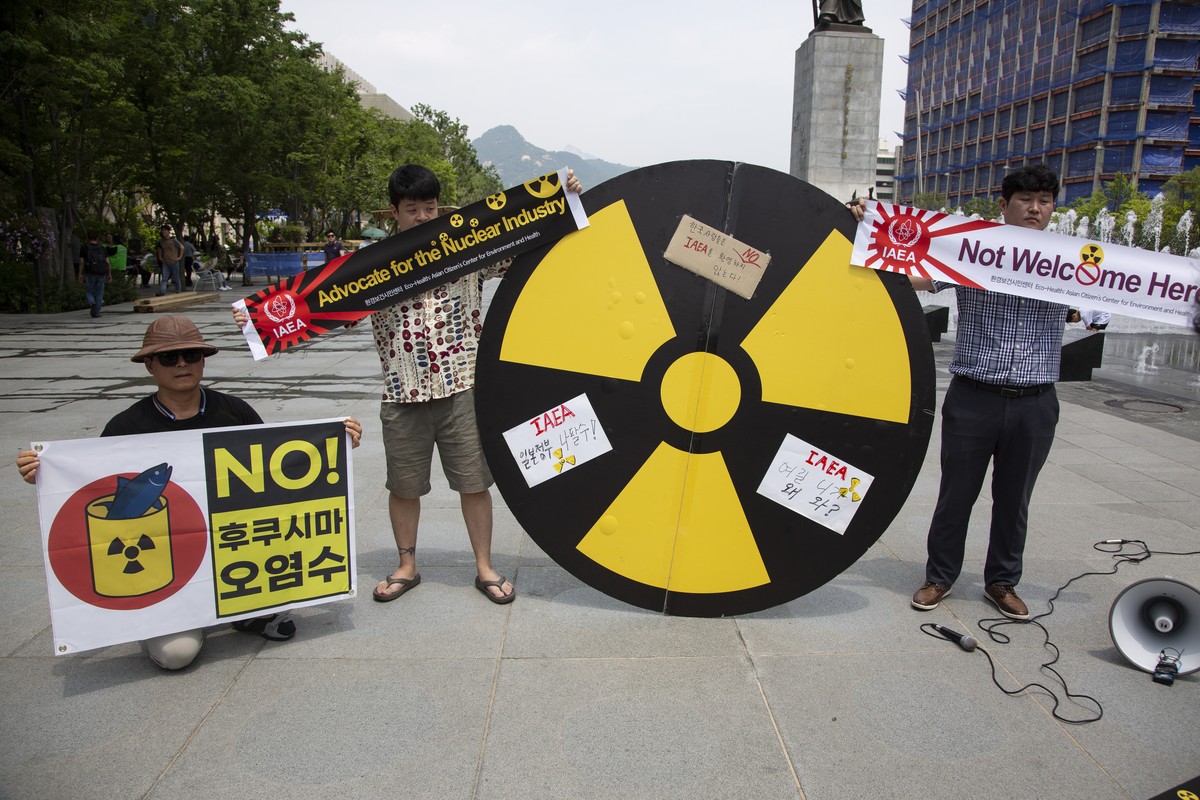epa10728879 Members of an environmental group hold banners reading 'No Fukushima radioactive water' during a rally against the Internationsl Atomic Energy Agency's (IAEA) report on Japa ...