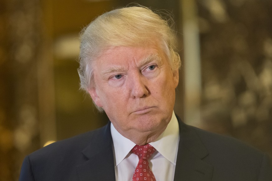 epa05708071 US President-elect Donald Trump speaks with journalists in the lobby of Trump Tower, after meeting with LVHM Fashion&#039;s Alexandre and Bernard Arnault, New York, New York, USA, 09 Janua ...