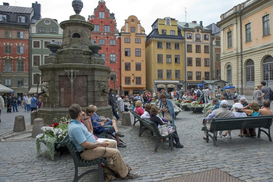 This is a July 26, 2011 file photo of tourists in Stortorget Square in the Old Town of Stockholm. Buildings from the 17th century stand askew, worn by time but meticulously repaired and repainted in s ...