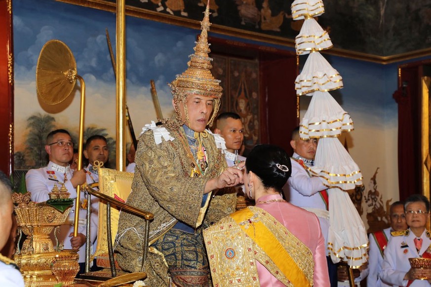 BANGKOK, THAILAND - MAY 04: In this handout image provided by the Public Relations for the Coronation of King Rama X, Thai King Maha Vajiralongkorn and his wife, Queen Suthida, during the coronation c ...