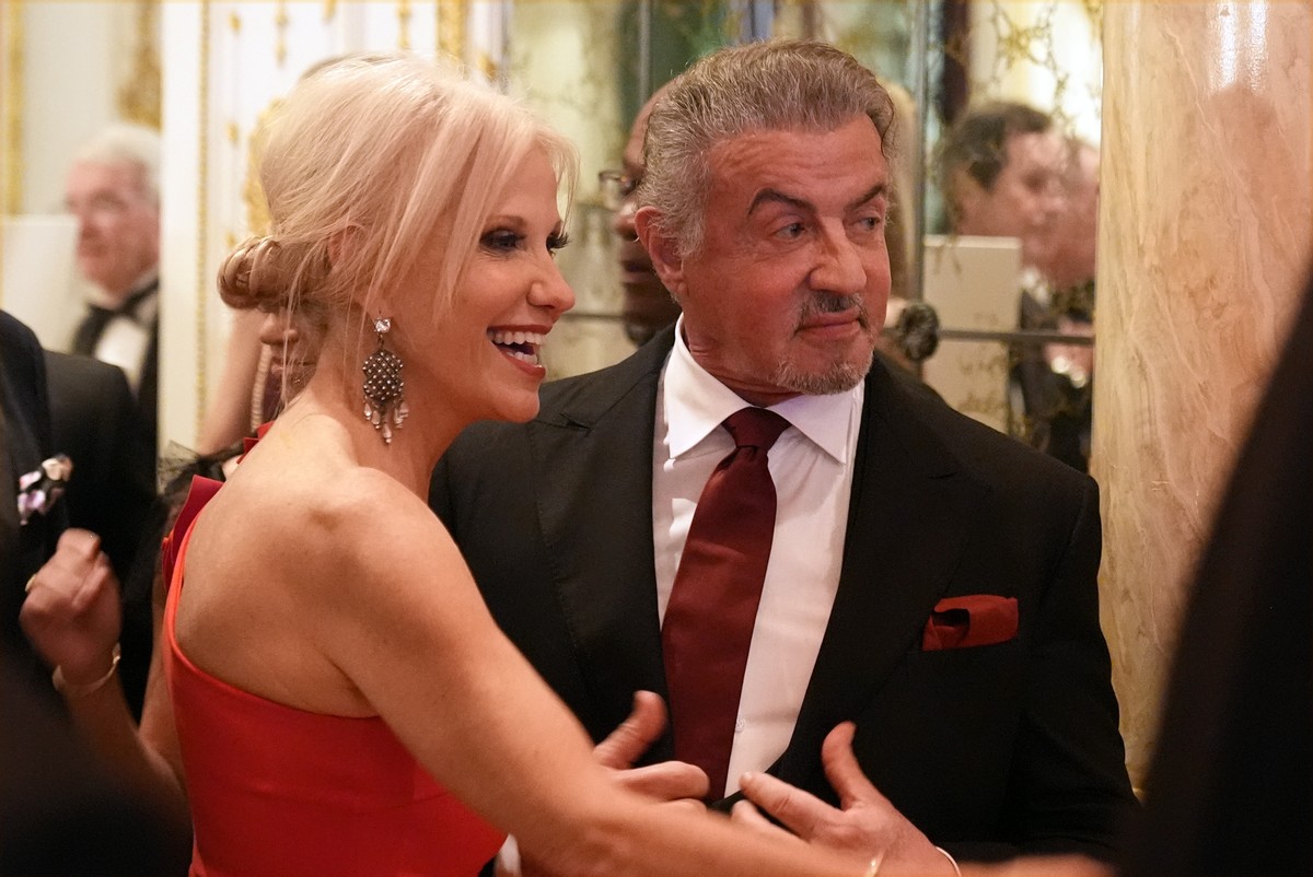 Sylvester Stallone stand with Kellyanne Conway as they arrive before President-elect Donald Trump speaks during an America First Policy Institute gala at his Mar-a-Lago estate, Thursday, Nov. 14, 2024 ...