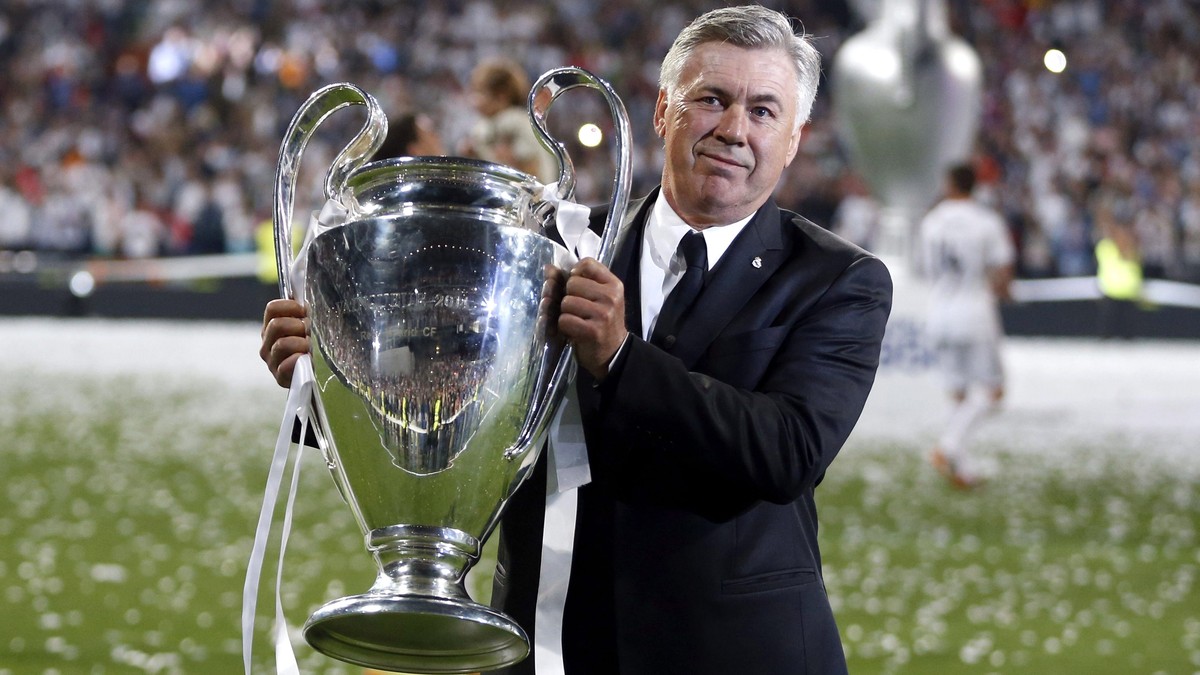 epa05076307 Real Madrid's Italian head coach Carlo Ancelotti holds the winner trophy during an event to celebrate their win in the UEFA Champions League held at Santiago Bernabeu stadium in Madri ...