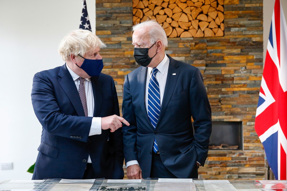 epa09260814 Boris Johnson, Britain's Prime Minster, gestures to US President Joe Biden, right, as they look at the Atlantic charter during their bilateral meeting in Carbis Bay, Britain, 10 June  ...