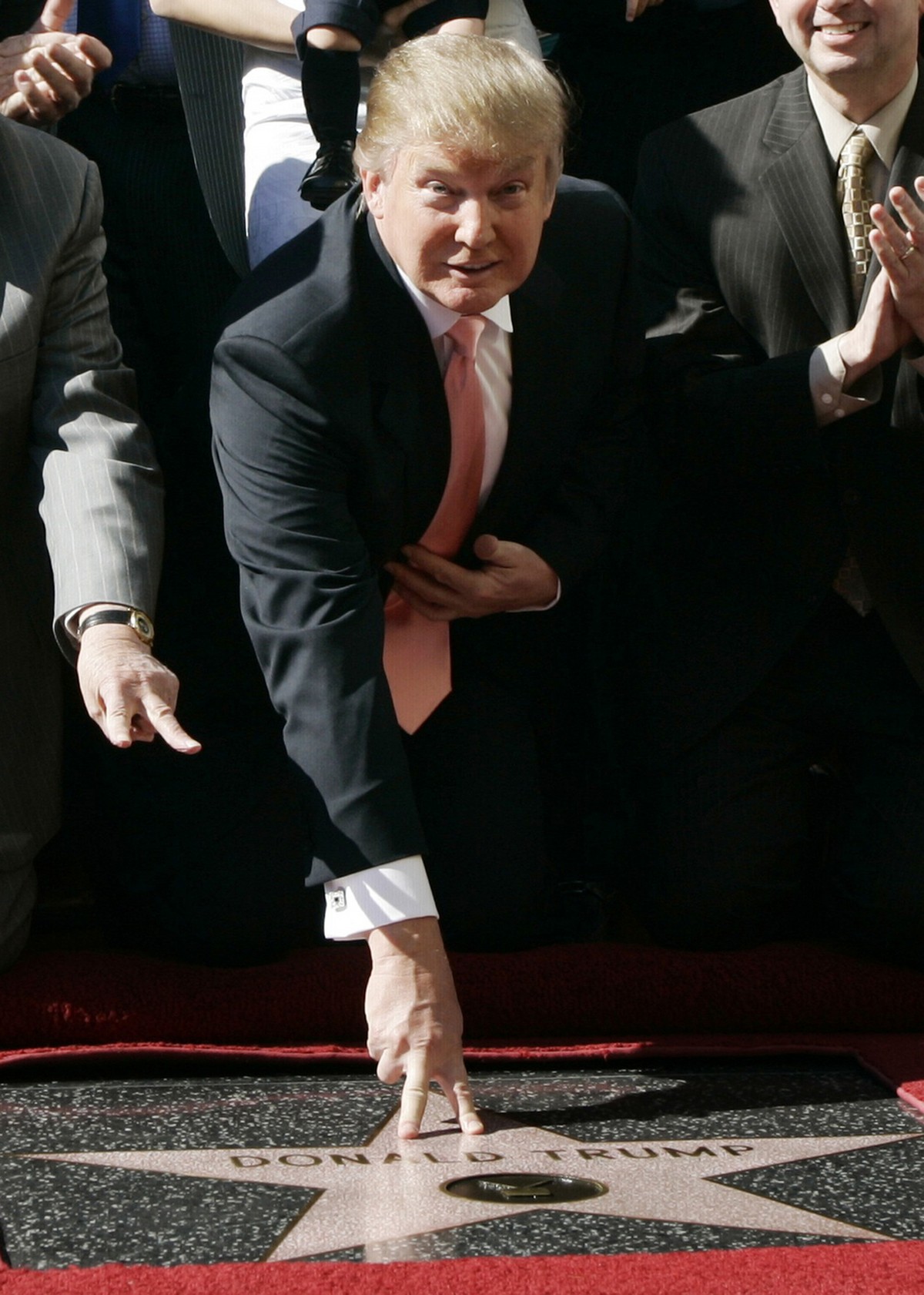 FILE - In this Jan. 16, 2007, file photo, Donald Trump, center, the billionaire and developer and producer of NBC's "The Apprentice," is honored with a star on the Hollywood Walk of Fam ...