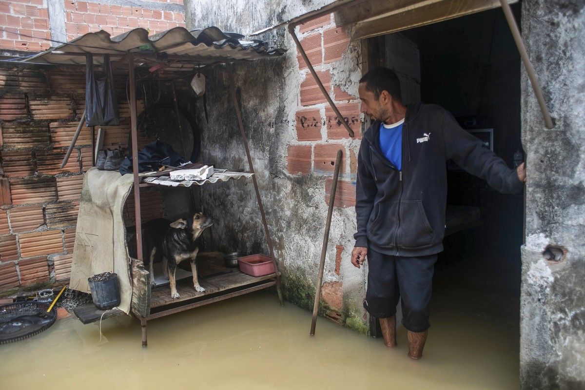 Nicelio Goncalves stands in his flooded home after heavy rains in Duque de Caxias, Brazil, Sunday, March 24, 2024. (AP Photo/Bruna Prado)