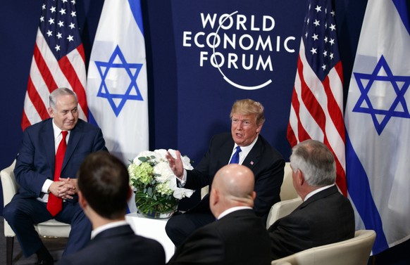 Israeli Prime Minister Benjamin Netanyahu looks on as President Donald Trump speaks during a meeting at the World Economic Forum, Thursday, Jan. 25, 2018, in Davos. (AP Photo/Evan Vucci)