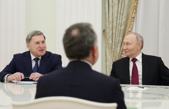 epa12565074 Russian President Vladimir Putin (R) and Russian Presidential Aide Yury Ushakov (L) meet with US Presidential Envoy Steve Witkoff (C) at the Kremlin in Moscow, Russia, 02 December 2025. Pu ...