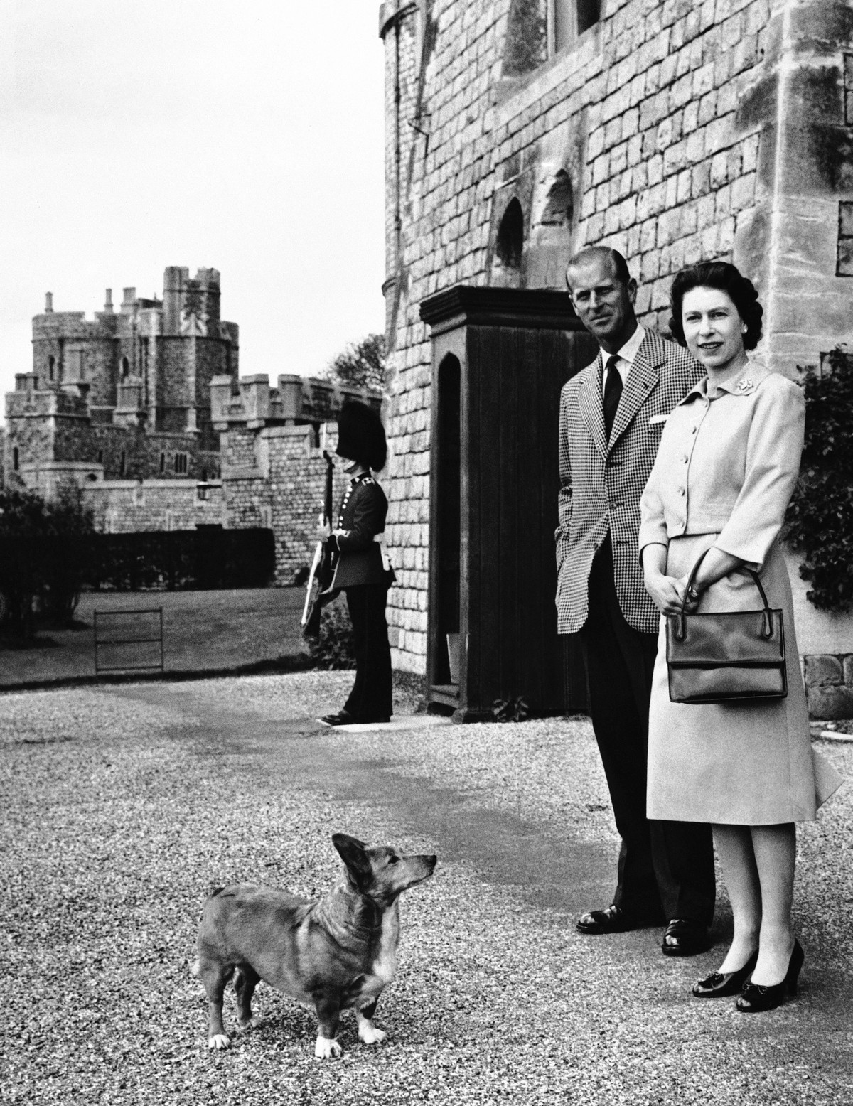FILE - Queen Elizabeth II and Prince Philip strolled near the George IV gateway of Britain's Windsor Castle on June 2, 1959. Queen Elizabeth II's corgis were a key part of her public persona ...