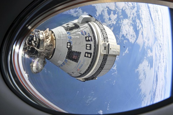 This photo provided by NASA shows Boeing&#039;s Starliner spacecraft which launched astronauts Butch Wilmore and Suni Williams to the International Space Station docked to the Harmony module&#039;s fo ...