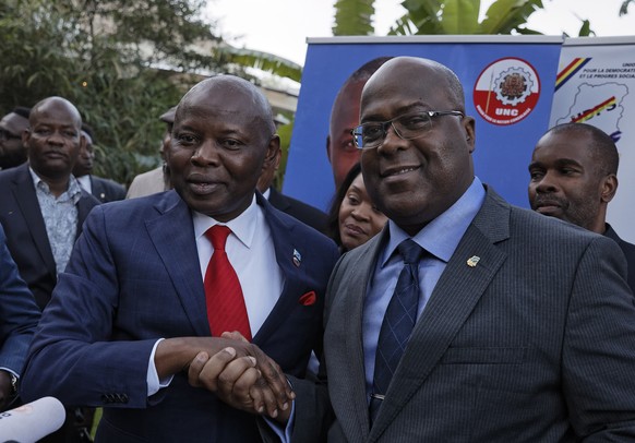 Felix Tshisekedi, right, of Congo&#039;s Union for Democracy and Social Progress opposition party, shakes hands with Vital Kamerhe of Congo&#039;s Union for the Congolese Nation opposition party, afte ...