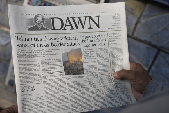 A Pakistani reads the front page of a morning newspaper about Iran's attack, at a stall in Islamabad, Pakistan, Thursday, January 18, 2024. The Pakistan Air Force launched retaliatory airstrikes...