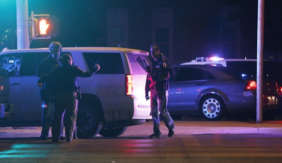 Emergency personnel stage at an intersection across from Talkington Hall on the Texas Tech University campus in Lubbock, Texas, Monday, Oct. 9, 2017. Police apprehended a 19-year-old student accused o ...