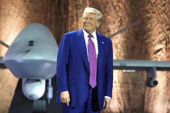 President Donald Trump smiles backdropped by an MQ-9 Reaper drone before addressing military personnel at the Al Udeid Air Base, Thursday, May 15, 2025, in Doha, Qatar. (AP Photo/Alex Brandon)
Donald  ...