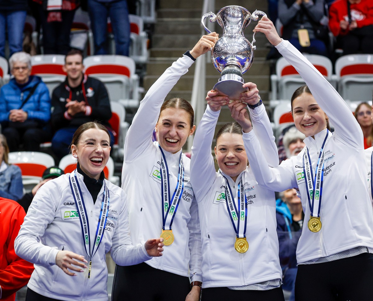 From left to right, Switzerland skip Xenia Schwaller, third Selina Gafner, vice-skip Fabienne Rieder and lead Selina Rychiger raise the trophy after defeating Canada to win the World Women's Curl ...