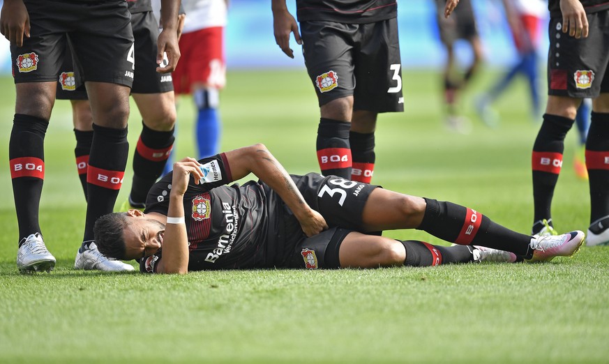 Leverkusen's Karim Bellarabi is injured and has to be replaced during the German Bundesliga soccer match between Bayer Leverkusen and Hamburger SV in Leverkusen, Germany, Saturday, Sept. 10, 2016. (AP ...