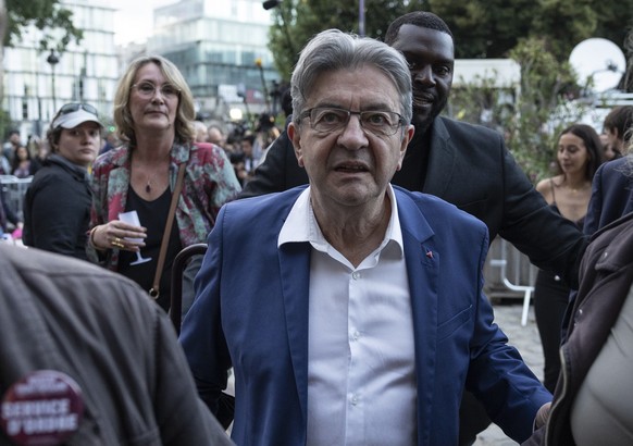 epa11465997 Leader of La France Insoumise (LFI) Jean-Luc Melenchon (C) leaves after his speech following the results of the second round of the legislative elections in Paris, France, 07 July 2024. Fr ...
