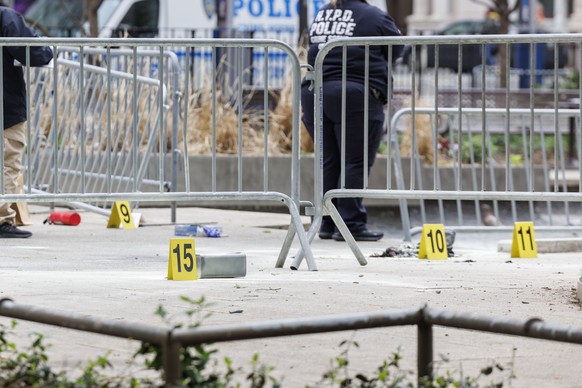 epa11289524 An emergency personnel investigates the scene after a man set himself on fire at Collect Pond Park, outside Manhattan Criminal Court where former president Donald Trump is attending jury s ...