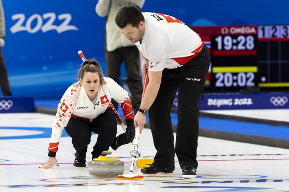 Jenny Perret, left, Martin Rios of Switzerland team, in action during the curling mixed doubles preliminary round game between China and Switzerland at the 2022 Olympic Winter Games in Beijing, China, ...