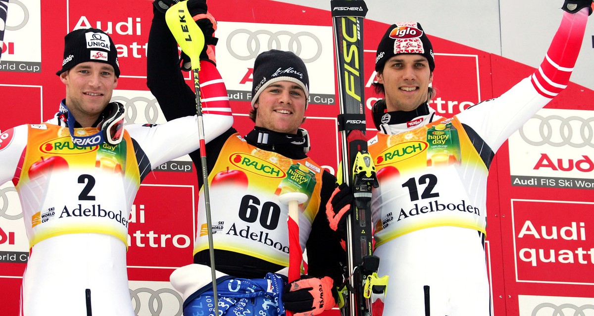 Switzerland's Marc Berthod, center, winner of the Alpine ski world Cup men's slalom race, celebrates on the podium with second placed Austria's Benjamin Raich, left, and third placed Au ...