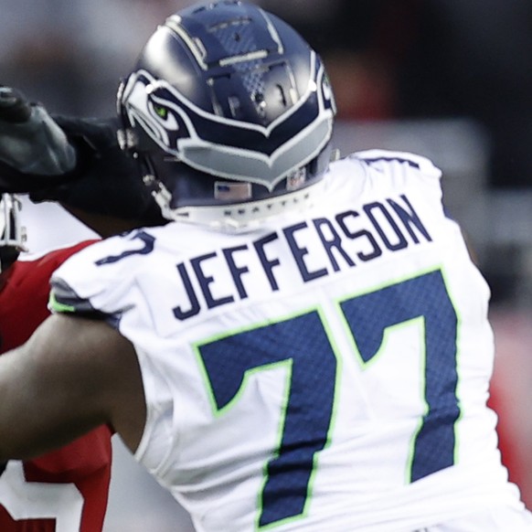 epa10406061 San Francisco 49ers quarterback Brock Purdy (L) drops back to pass as San Francisco 49ers defensive tackle Akeem Spence (C) blocks Seattle Seahawks defensive tackle Quinton Jefferson (R) d ...