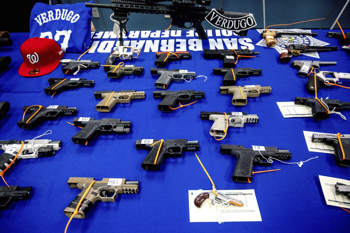 Firearms, seized from a multiagency operation targeting the Westside Verdugo criminal street gang, are displayed during a press conference at the San Bernardino Police Station, Thursday, Dec. 9, 2021, ...