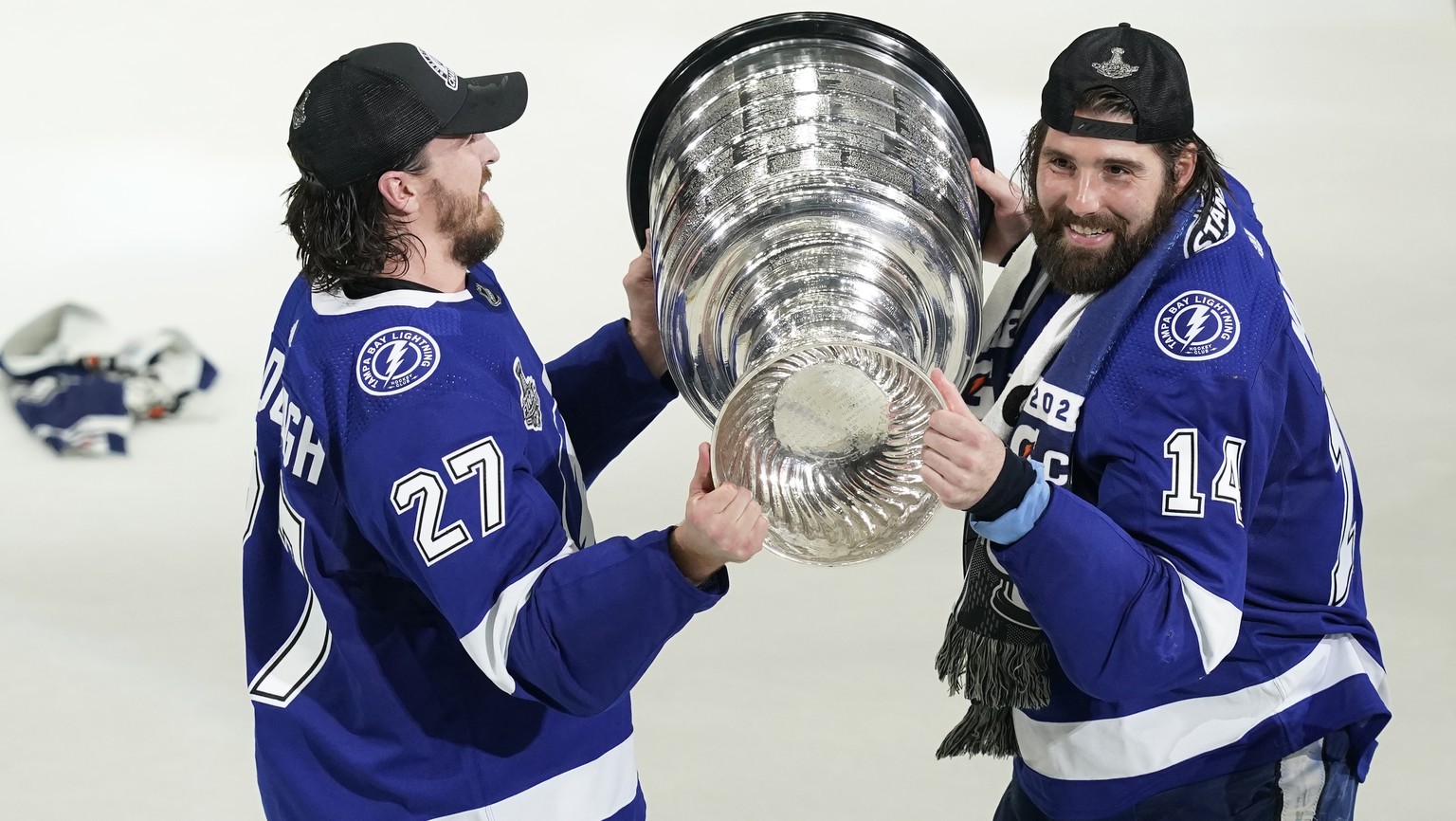 Tampa Bay Lightning defenseman Ryan McDonagh (27) hands the Stanley Cup to left wing Pat Maroon (14) after the series win in Game 5 of the NHL hockey Stanley Cup finals against the Montreal Canadiens, ...