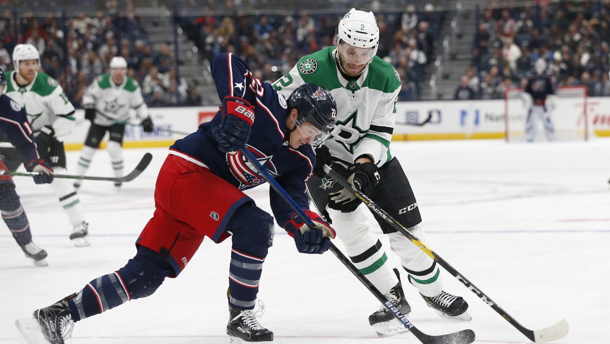 Dallas Stars' Jamie Oleksiak, right, and Columbus Blue Jackets' Sonny Milano vie for the puck during the second period of an NHL hockey game Wednesday, Oct. 16, 2019, in Columbus, Ohio. (AP  ...