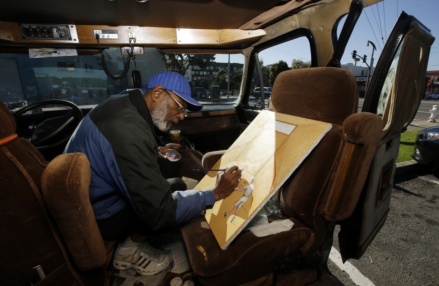 In this Nov. 10, 2015, photo, Ira Watkins, a homeless artist, works on a painting inside of the van where he works and lives in the Bayview-Hunters Point district in San Francisco. As San Francisco ri ...