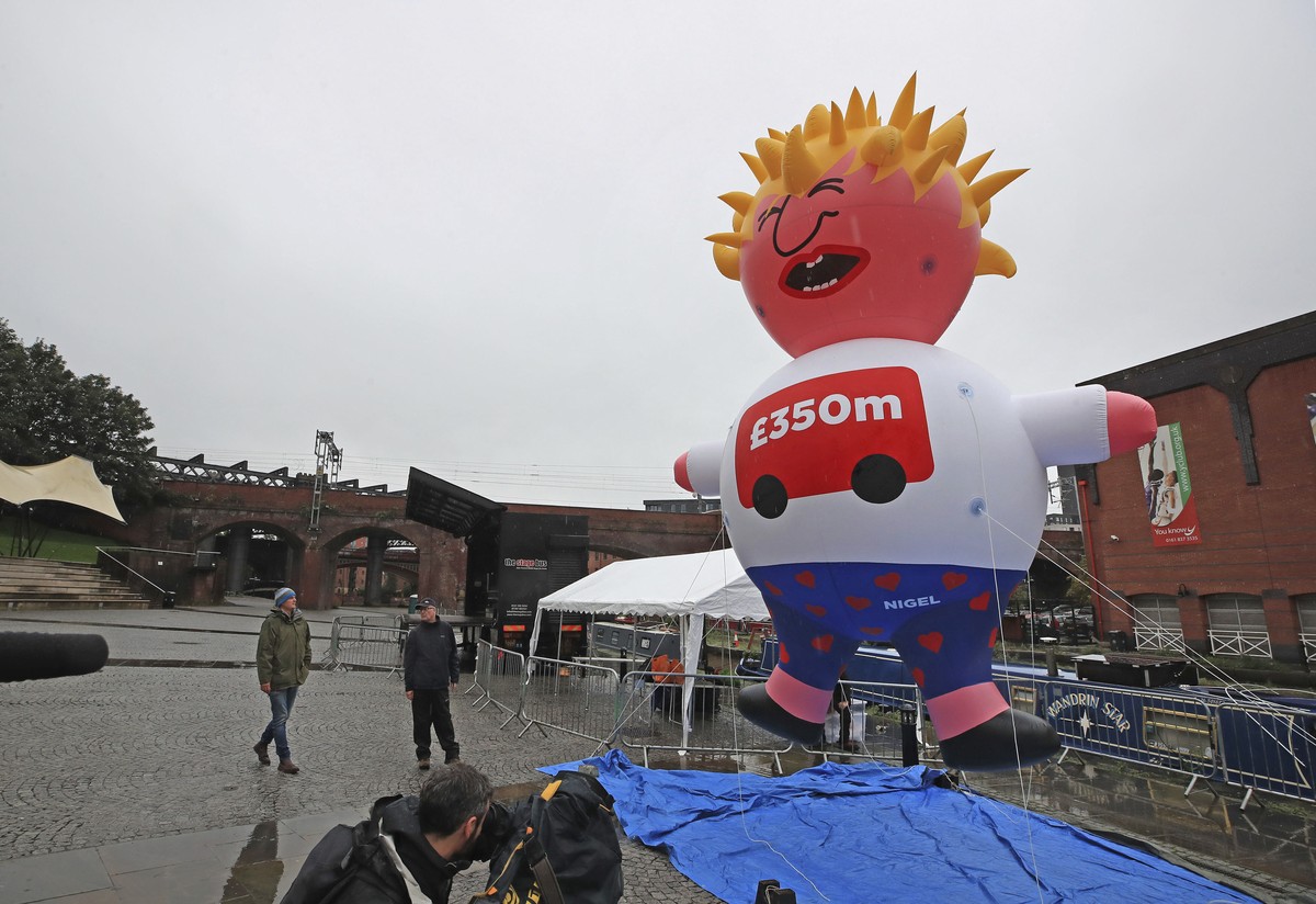 A blimp of Britain's Prime Minister Boris Johnson is inflated as part of the Reject Brexit defend our democracy protest, before the Conservative party conference in Manchester, England, Sunday, S ...