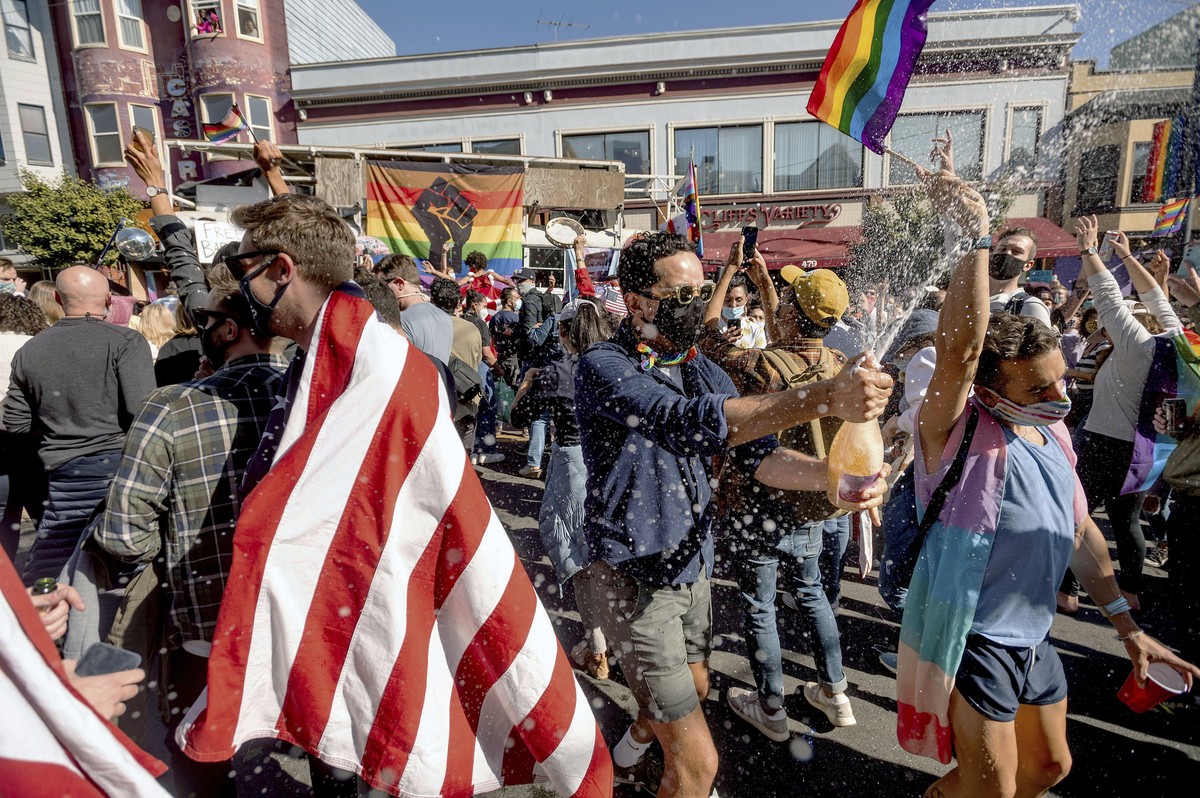 Peter Puga sprays champagne while celebrating the victory of President-elect Joe Biden and Vice President-elect Kamala Harris in San Francisco's Castro district on Saturday, Nov. 7, 2020. (AP Pho ...
