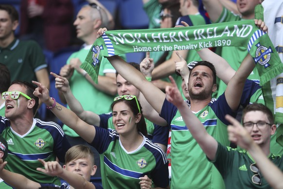 Fans of Northern Ireland cheer before the start of the Euro 2016 round of 16 soccer match between Wales and Northern Ireland, at the Parc des Princes stadium in Paris, Saturday, June 25, 2016. (AP Pho ...