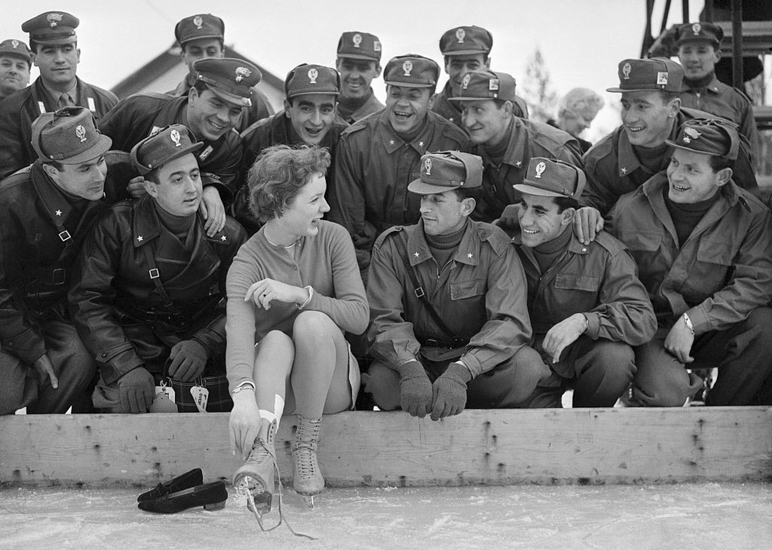 (Original Caption) Soldiers are the same all over the world. These Italian soldiers here are having the time of their life watching Tenley Albright, of the USA,and last year's figure skating worl ...