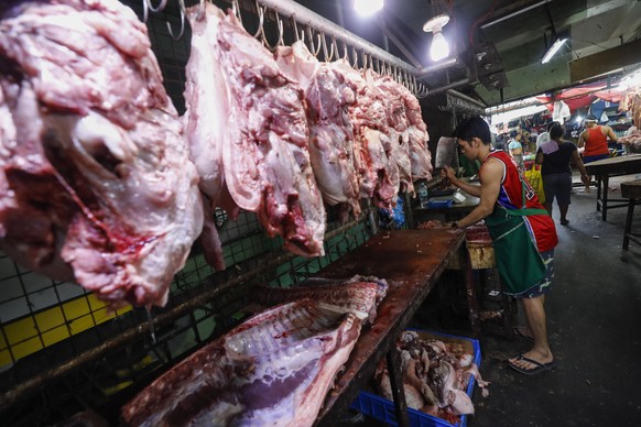 epa07068097 A Filipino vendor chops meat parts sold at a market in Quezon City, east of Manila, Philippines, 04 October 2018. According to the report 'Navigating Uncertainty', the October 2018 edition ...